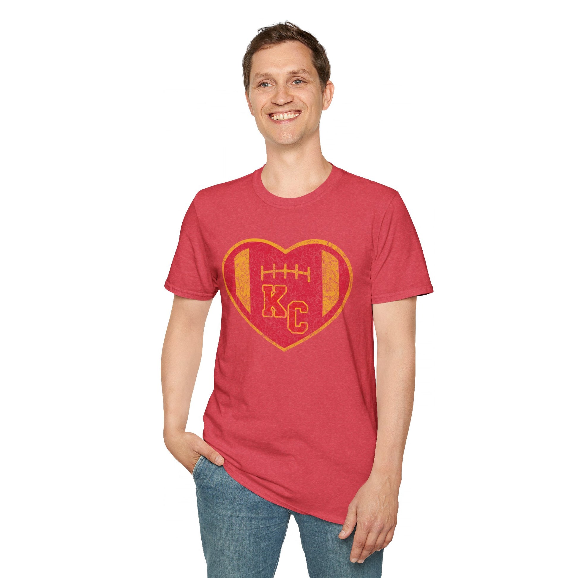 The KC Inspirations Vintage KC Heart Red & Gold - Kansas City Chiefs Inspired T-Shirt is a black T-shirt featuring a heart-shaped design in the center with a red and gold color scheme. Inside the heart is a football and the letters "KC," symbolizing Kansas City football. The vintage KC Heart design has distressed graphics, giving it an authentic, worn-in look.