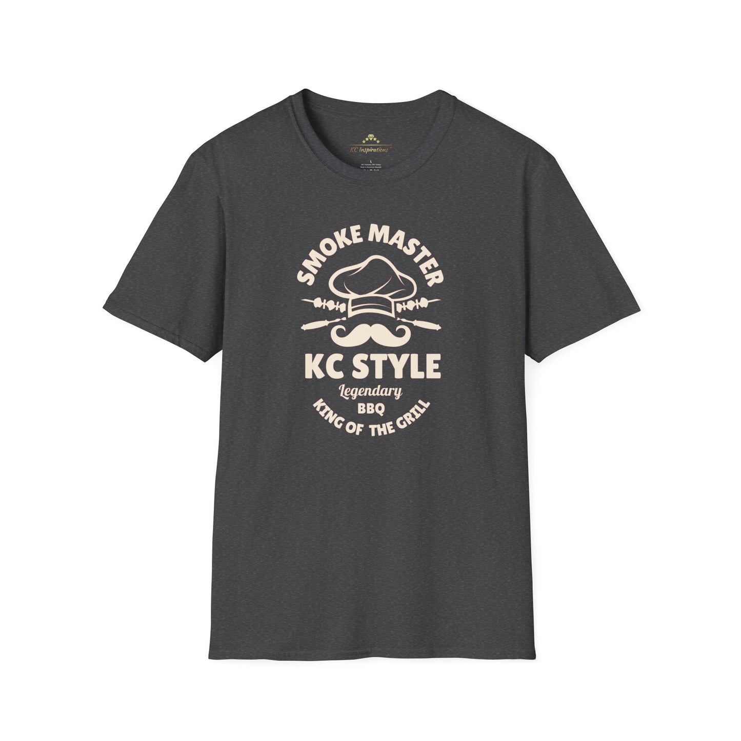 A brown Smoke Master - K.C. BBQ Inspired T-Shirt by KC Inspirations with a graphic text that reads "Smoke Master KC Style Legendary BBQ King of the Grill" accompanied by a mustache, crossed spatulas, and a chef's hat illustration in light beige, perfect for any barbecue enthusiast.