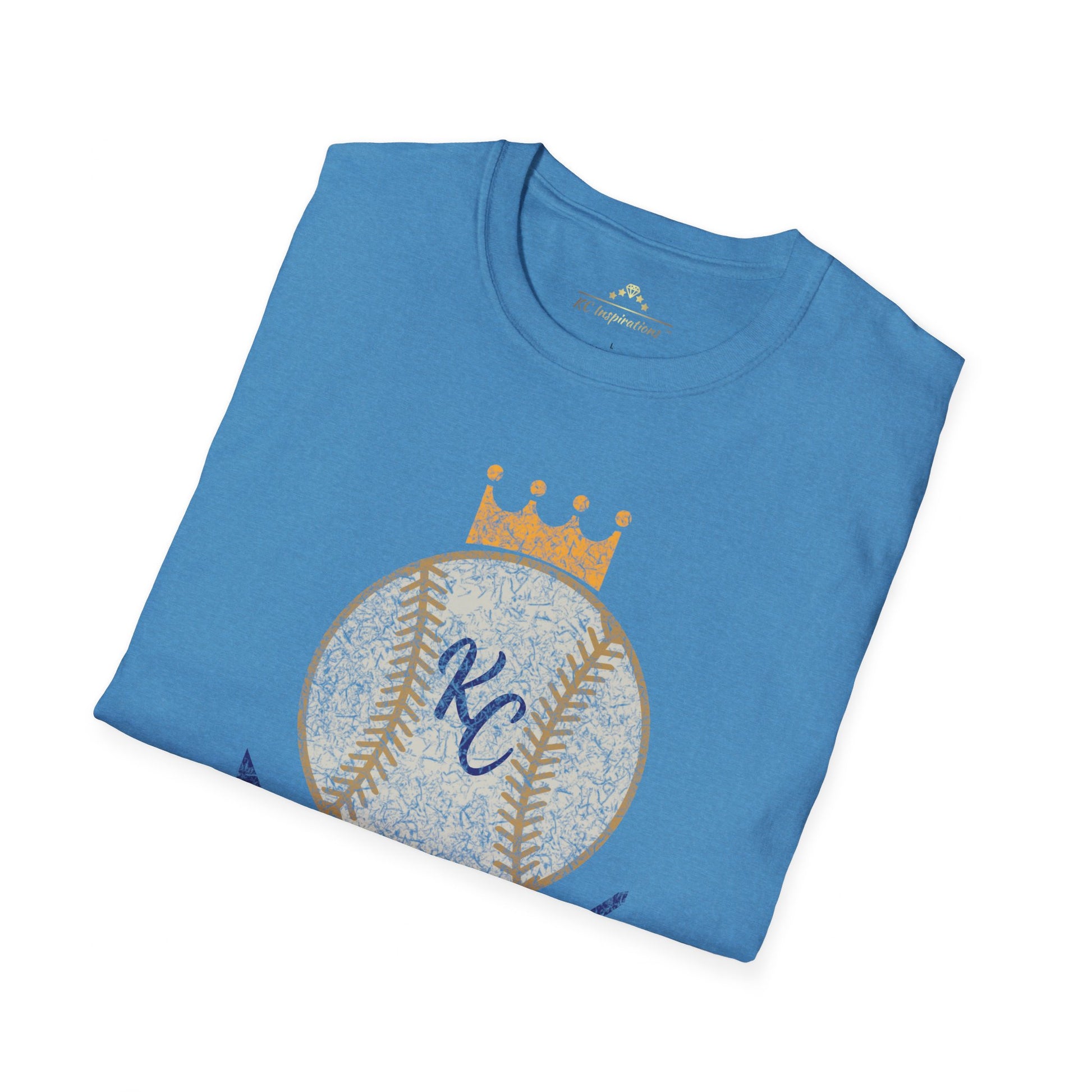 Light blue vintage Crown Baseball - Kansas City Royals Inspired T-Shirt featuring a graphic of a baseball with a crown on top. The letters "KC" are written in the center of the ball, and "Royals" is written in bold, navy blue text below the baseball graphic—a perfect tribute for Kansas City Royals fandom by KC Inspirations.