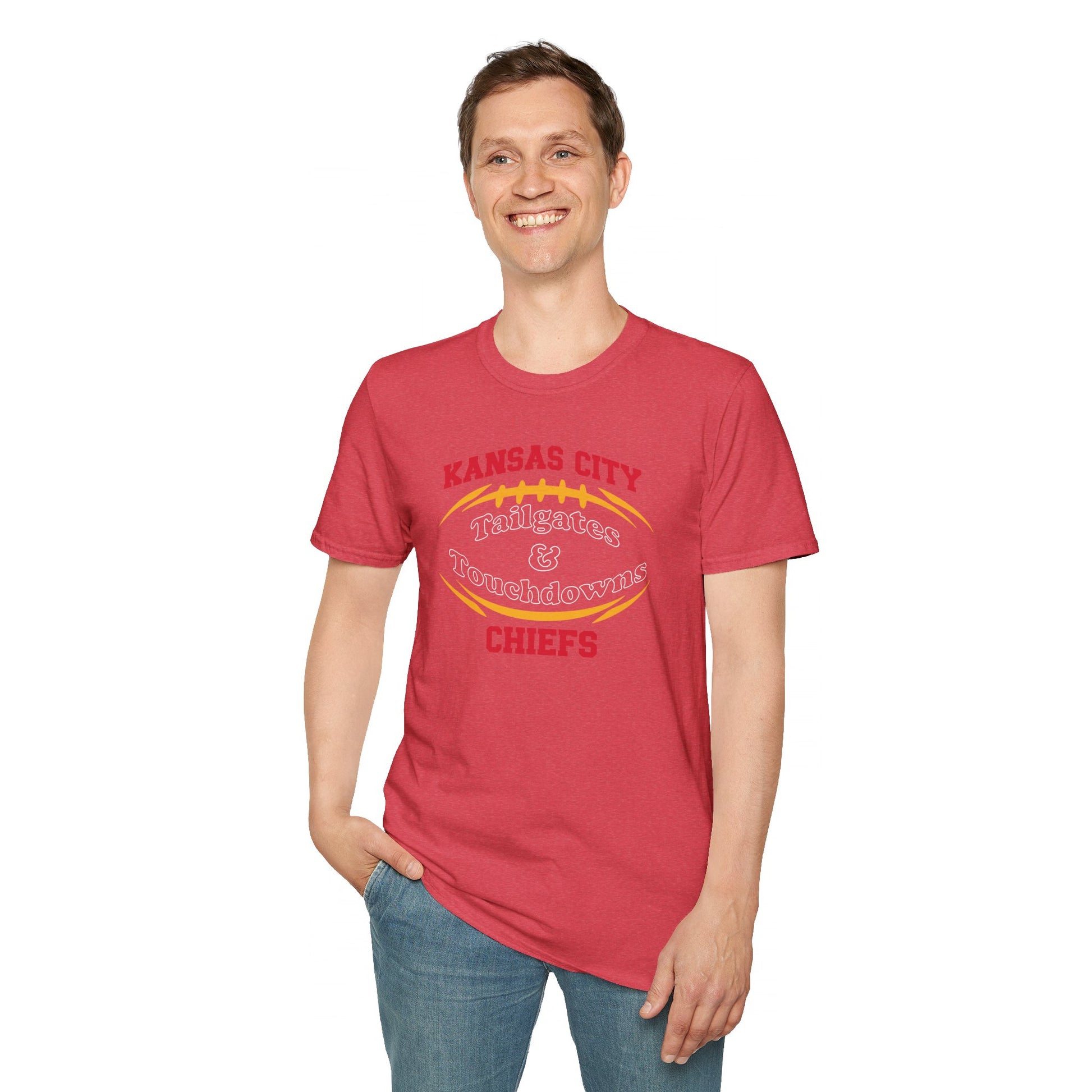 A dark gray Kansas City Chiefs t-shirt with "Kansas City Tailgates & Touchdowns Chiefs" written in bold red and yellow letters. The text is designed within the outline of a football, with "Chiefs" prominently featured at the bottom—perfect game day attire to show your team spirit. This is the **Tailgates & Touchdowns - Kansas City Chiefs Inspired T-Shirt** by **KC Inspirations**.