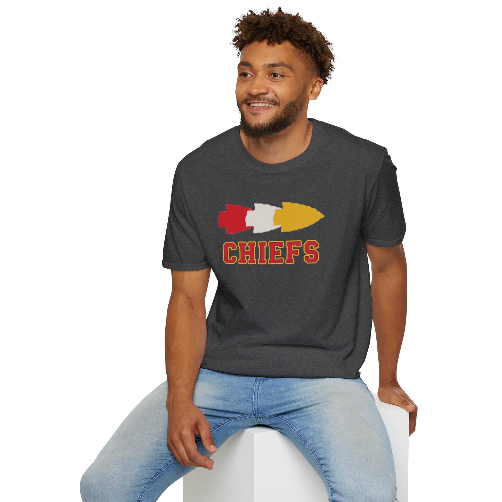 A black t-shirt perfect for game day attire, featuring a stylized arrowhead design in red, white, and yellow above the word "CHIEFS" in bold, red letters outlined in yellow. Show your Kansas City Chiefs pride with this standout piece. The Triple Arrowhead - Kansas City Chiefs Inspired T-Shirt by KC Inspirations is just what you need!