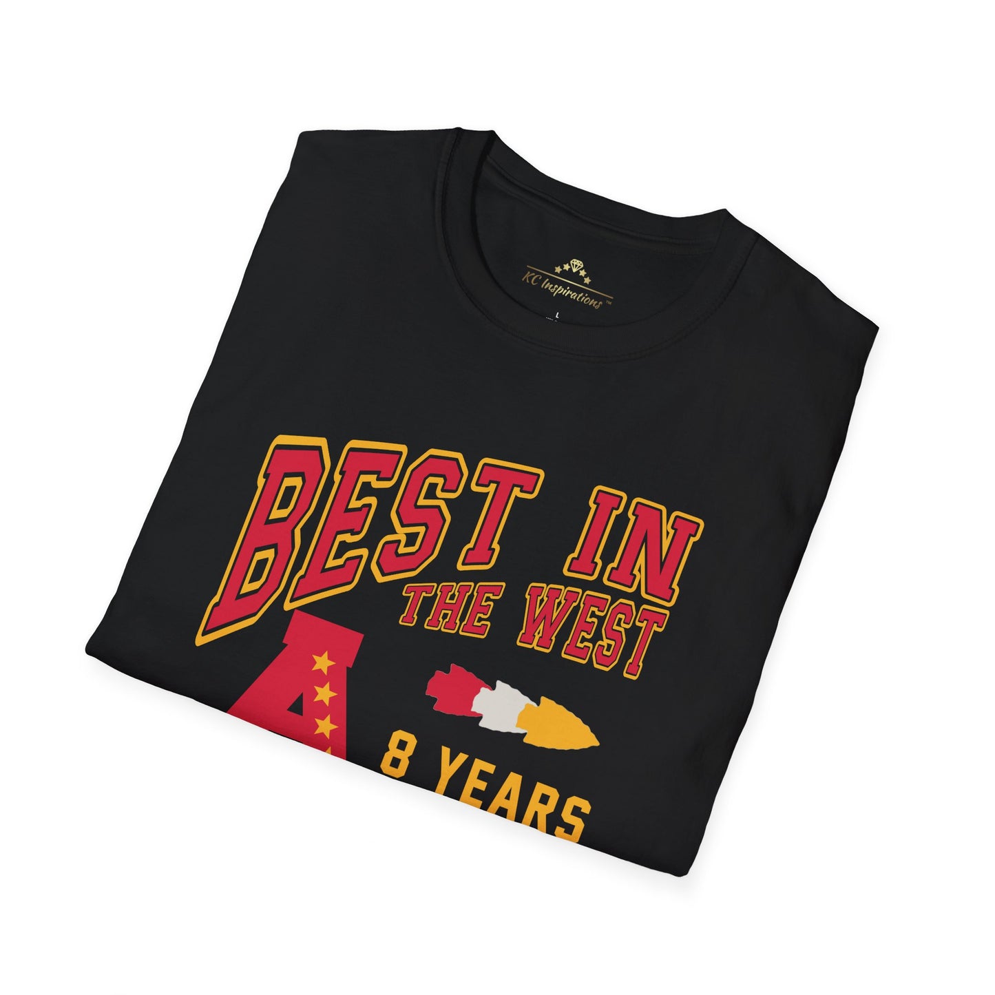 A folded black "Best In The West - Kansas City Chiefs Inspired T-Shirt" by KC Inspirations boasts bold text in red and yellow proclaiming "BEST IN THE WEST." Alongside an illustration of a map, a rocket, and the number 8 with the text "8 YEARS," it's perfect for celebrating the Kansas City Chiefs' AFC West Division Title.