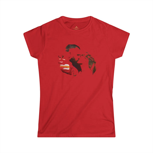 This Kansas City Chiefs-inspired women's T-shirt from KC Inspirations, named Swelce Kiss 89, features a red background with an artistic, abstract print in the center. The design incorporates black and white brushstrokes forming the rough shape of two faces. Part of our fan gear collection, it has a classic fit and a round neckline.