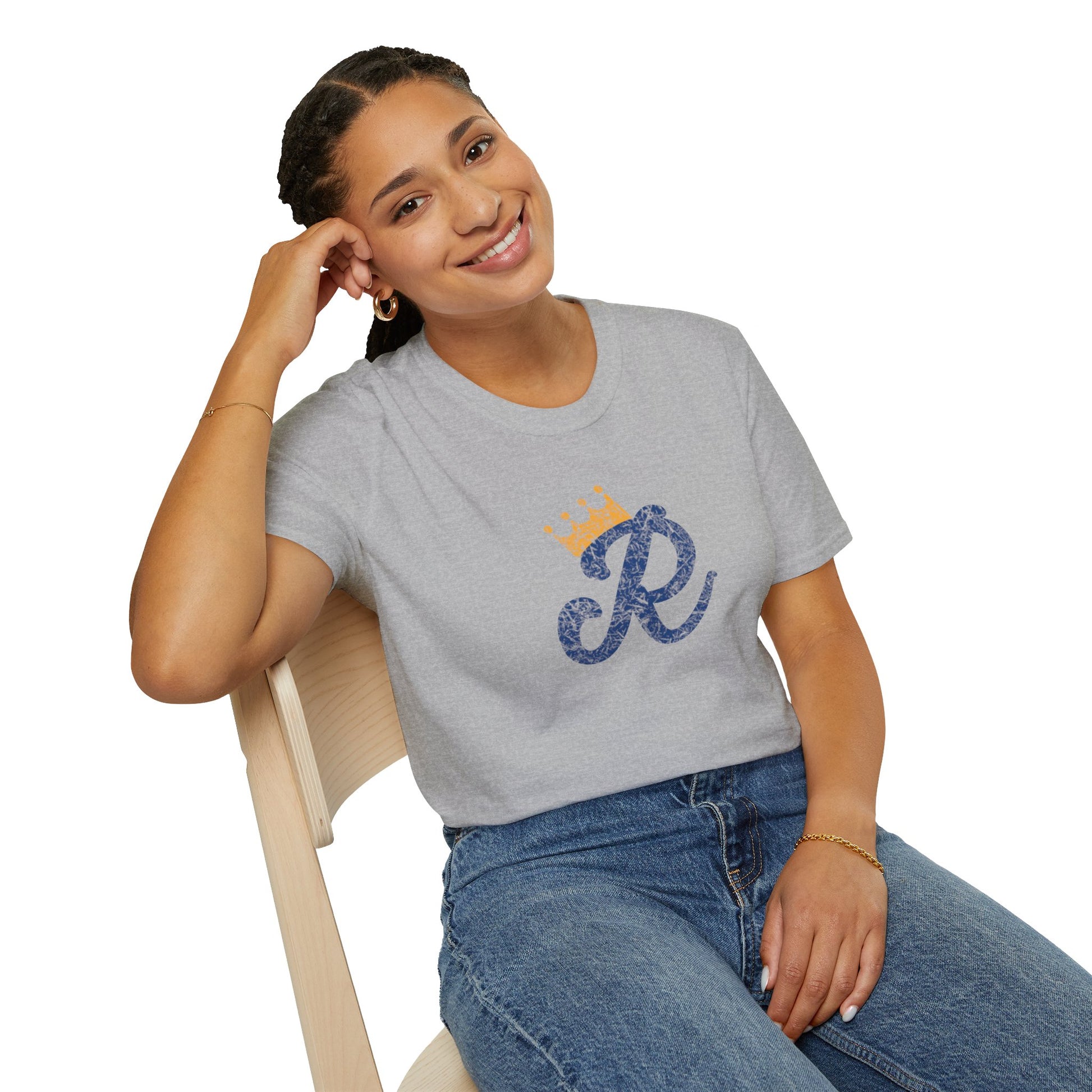 A Royal Monogram - Kansas City Royals Inspired T-Shirt by KC Inspirations in blue features a stylized letter "R" in dark blue textured print on the front, with a small golden crown above it. Perfect for Royals fandom, this short-sleeved tee has a classic crew neckline.