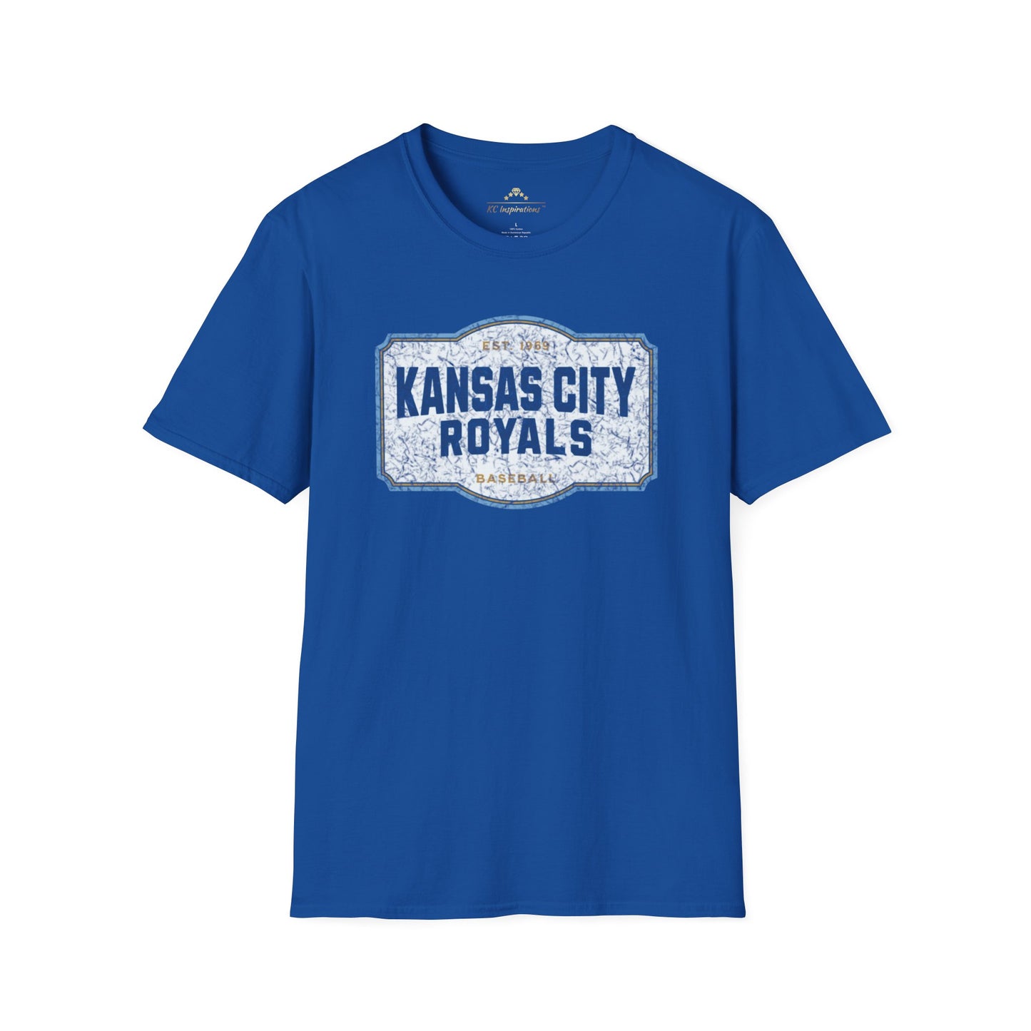 A light blue T-shirt with a graphic label in the center displaying "Kansas City Royals Baseball" in bold blue letters. The text "Est. 1969" is shown above the main text, giving it a vintage throwback look. Perfect for showing team spirit, this distressed T-shirt, Royal Badge - Kansas City Royals Inspired T-Shirt by KC Inspirations, is displayed on a white background.