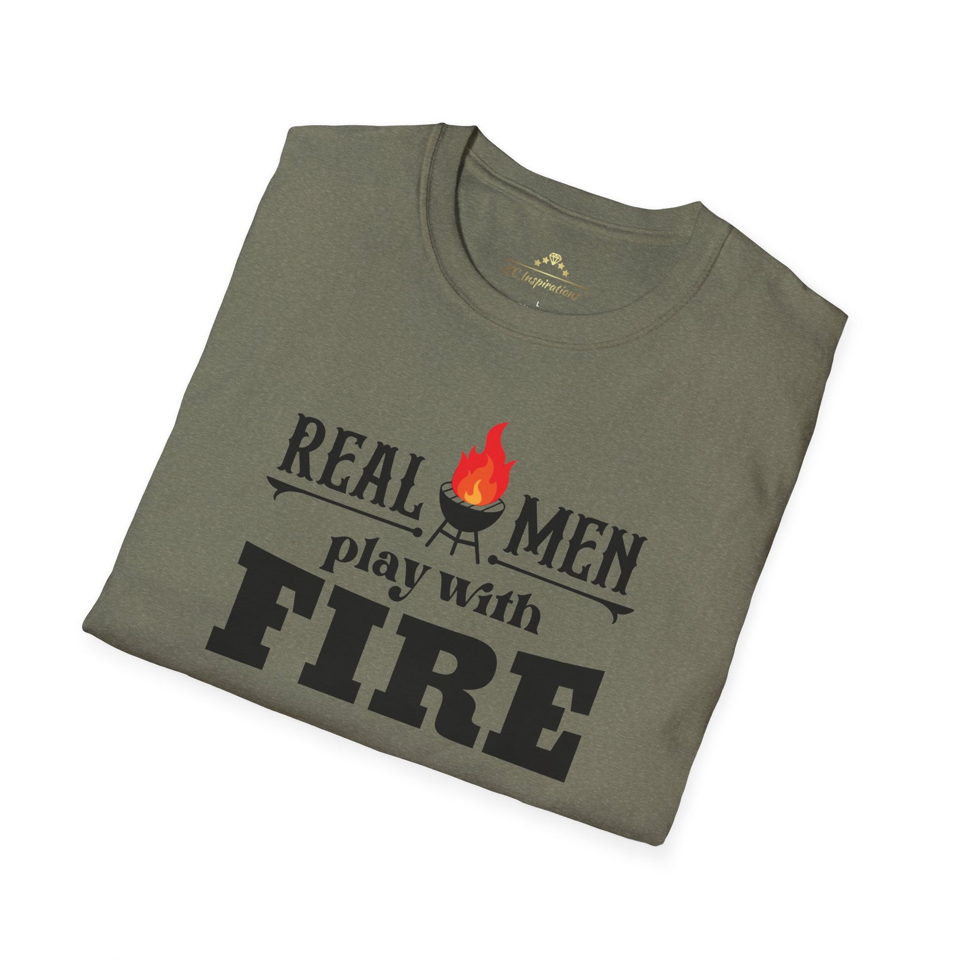 A gray-green Real Men Play With Fire - K.C. BBQ Inspired T-Shirt, featuring bold black letters and a flame icon above the "i" in "fire," is made from breathable lightweight fabric. Perfect for a casual ensemble, this shirt by KC Inspirations is displayed on a plain white background.