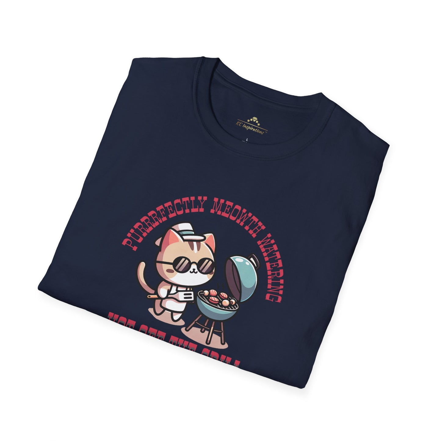 Navy blue t-shirt featuring a cartoon image of a cat in a chef's hat grilling food. Text above the design reads, "Purrsonally Midnight Brewing," and text below reads, "Hot Off The Grill." Perfect for BBQ enthusiasts who adore kittens and KC Barbecue culture. Introducing the Purrrfectly Hot Off The Grill - K.C. BBQ Inspired T-Shirt by Printify.