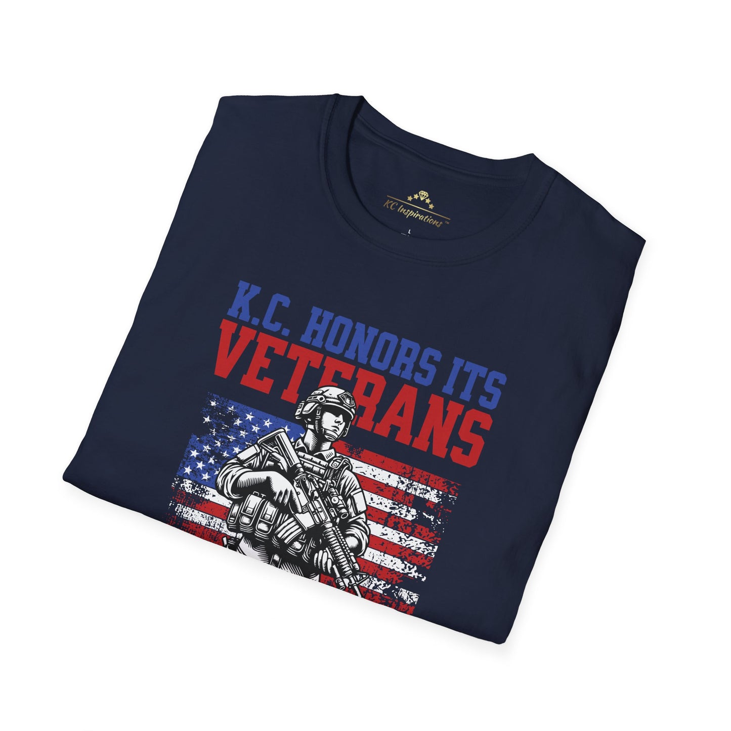 A navy blue KC Honors Its Veterans - Kansas City Inspired T-Shirt featuring a soldier with the American flag in the background. Text above reads "KC Honors Its Veterans," and below it reads "All Gave Some ★★★ Some Gave All." Perfect for showing your support for the veteran community. Brought to you by KC Inspirations.