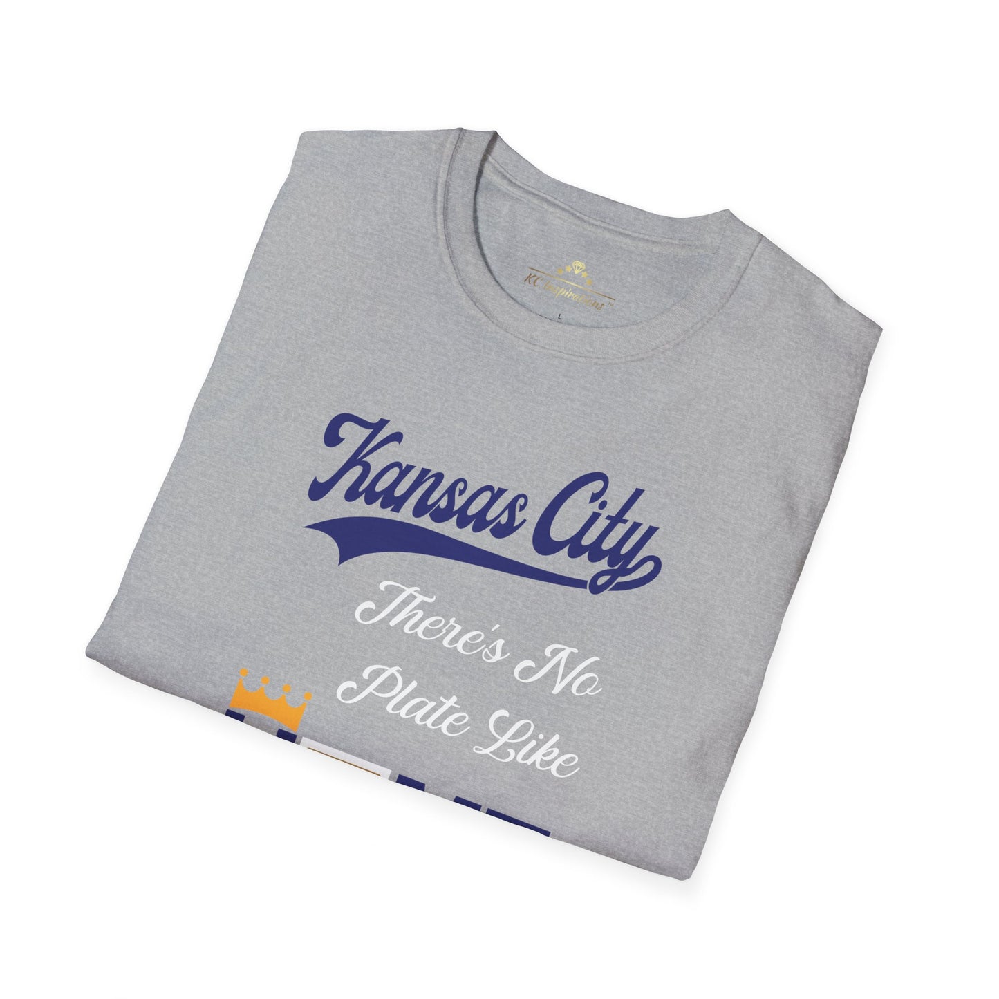 The No Plate Like Home - Kansas City Royals Inspired T-Shirt by KC Inspirations features crisp graphics and the phrase "Kansas City" in blue script at the top. Below it, the text "There's No Plate Like" is written in white, and at the bottom "HOME" is in blue, with the letter "O" depicted as a baseball home plate with a yellow crown on top. Perfect baseball fan apparel.