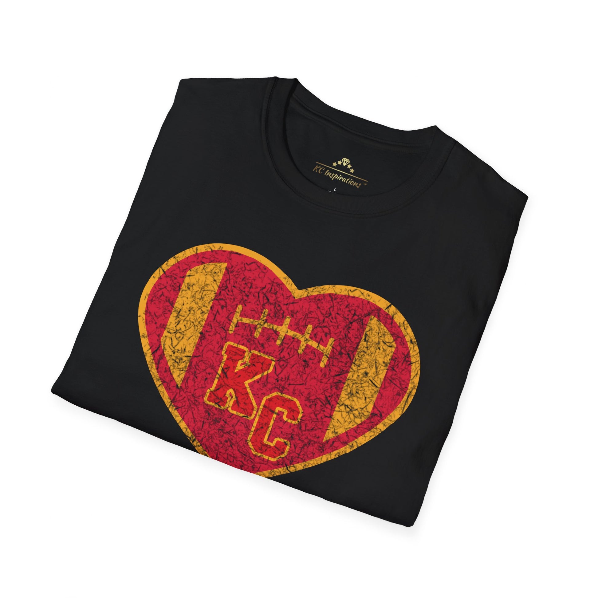 The KC Inspirations Vintage KC Heart Red & Gold - Kansas City Chiefs Inspired T-Shirt is a black T-shirt featuring a heart-shaped design in the center with a red and gold color scheme. Inside the heart is a football and the letters "KC," symbolizing Kansas City football. The vintage KC Heart design has distressed graphics, giving it an authentic, worn-in look.