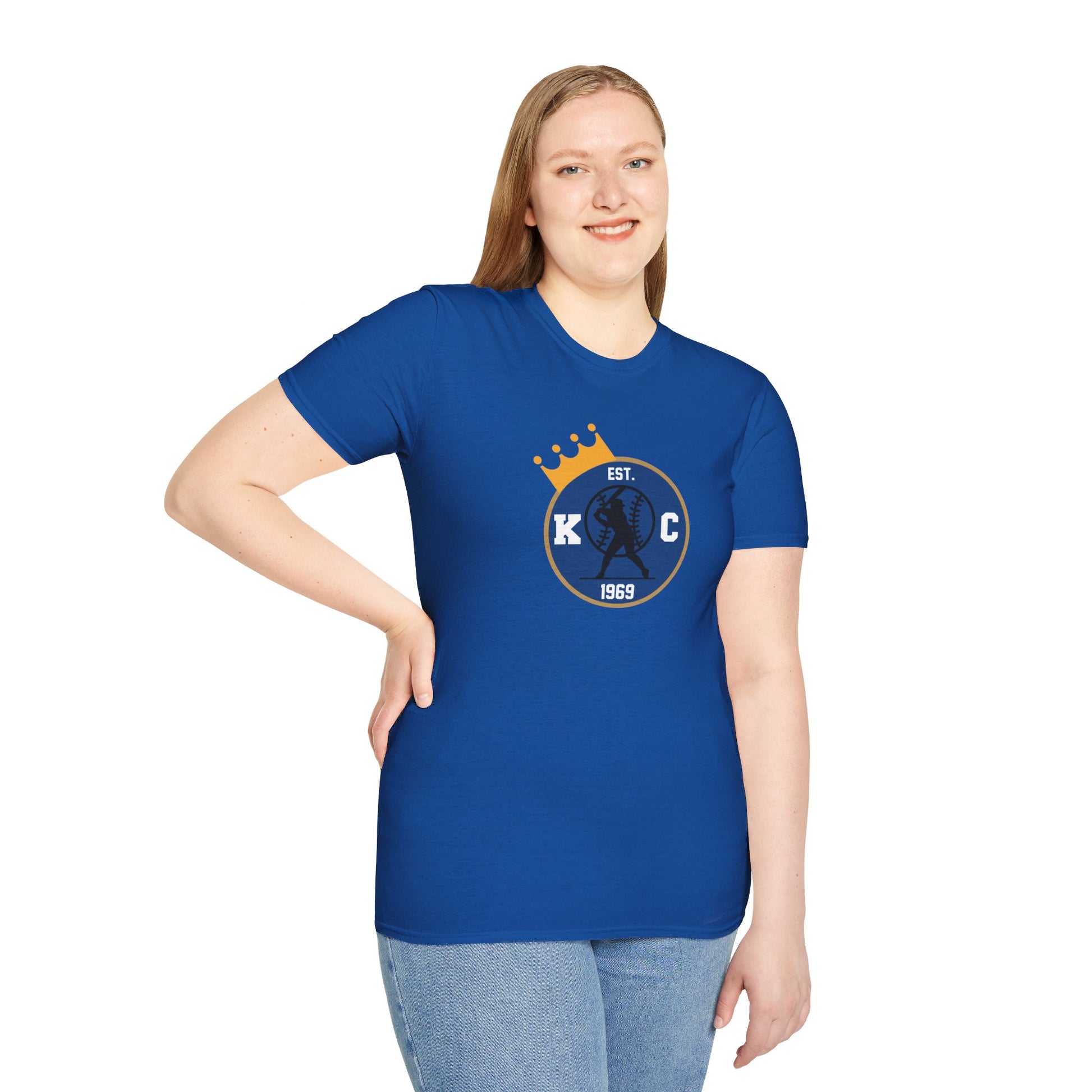 Gray T-shirt showcasing the KC Crowned Round - Kansas City Royals Inspired T-Shirt design with a circular blue logo featuring "KC," crossed baseball bats, and "EST 1969." A small yellow crown sits above the logo, perfect for showing your Kansas City Royals team spirit. Brought to you by KC Inspirations.