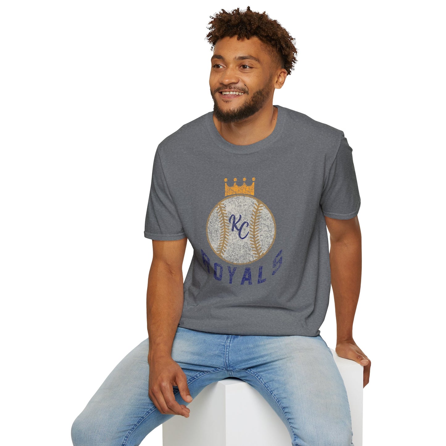 Light blue vintage Crown Baseball - Kansas City Royals Inspired T-Shirt featuring a graphic of a baseball with a crown on top. The letters "KC" are written in the center of the ball, and "Royals" is written in bold, navy blue text below the baseball graphic—a perfect tribute for Kansas City Royals fandom by KC Inspirations.