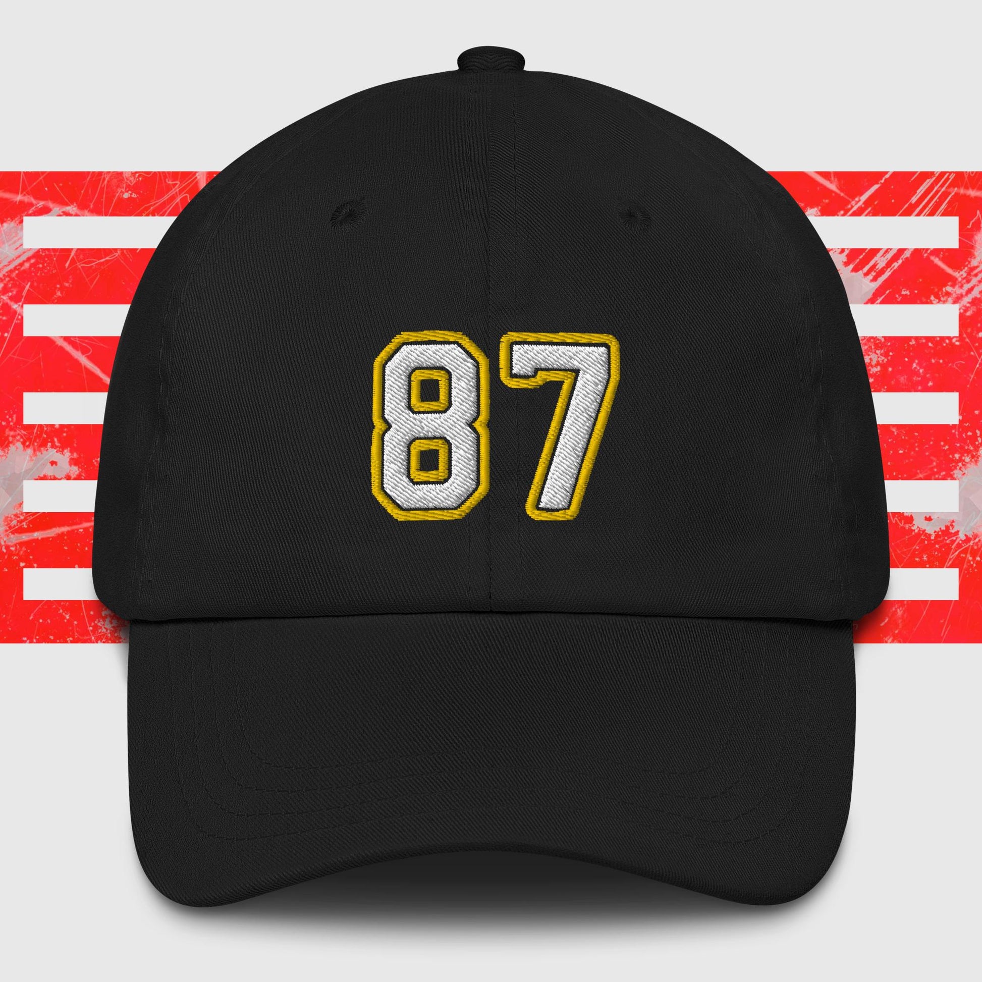 A White & Gold 87 - Kansas City Chiefs Inspired Cap from KC Inspirations. The background features red and white horizontal stripes with a distressed texture, reminiscent of Kansas City Chiefs spirit.