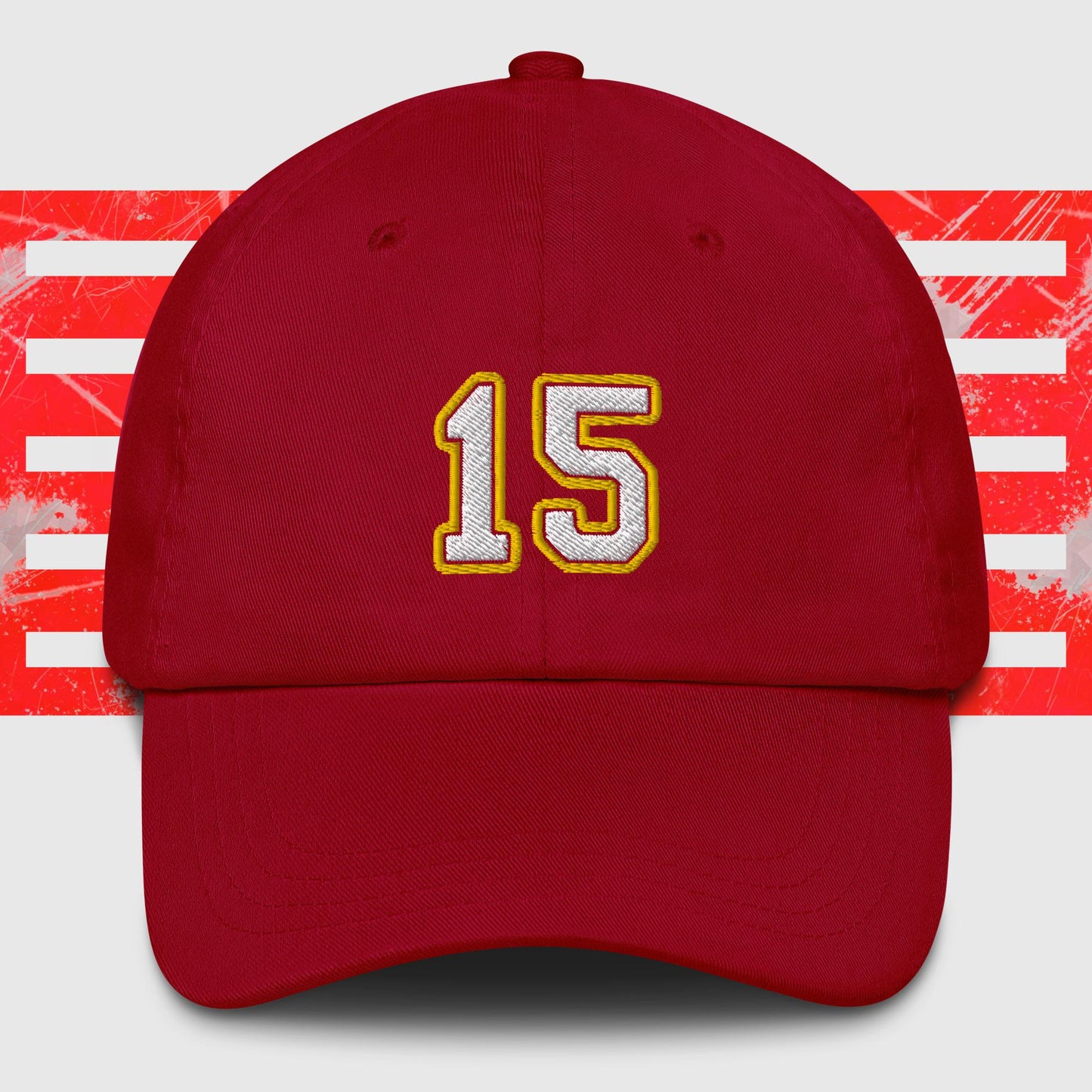 A White & Gold 15 - Kansas City Chiefs Inspired Cap by KC Inspirations with the number "15" embroidered in white and outlined in yellow on the front. The background features horizontal red and white stripes with a distressed texture. This hat also boasts an adjustable strap for a perfect fit.