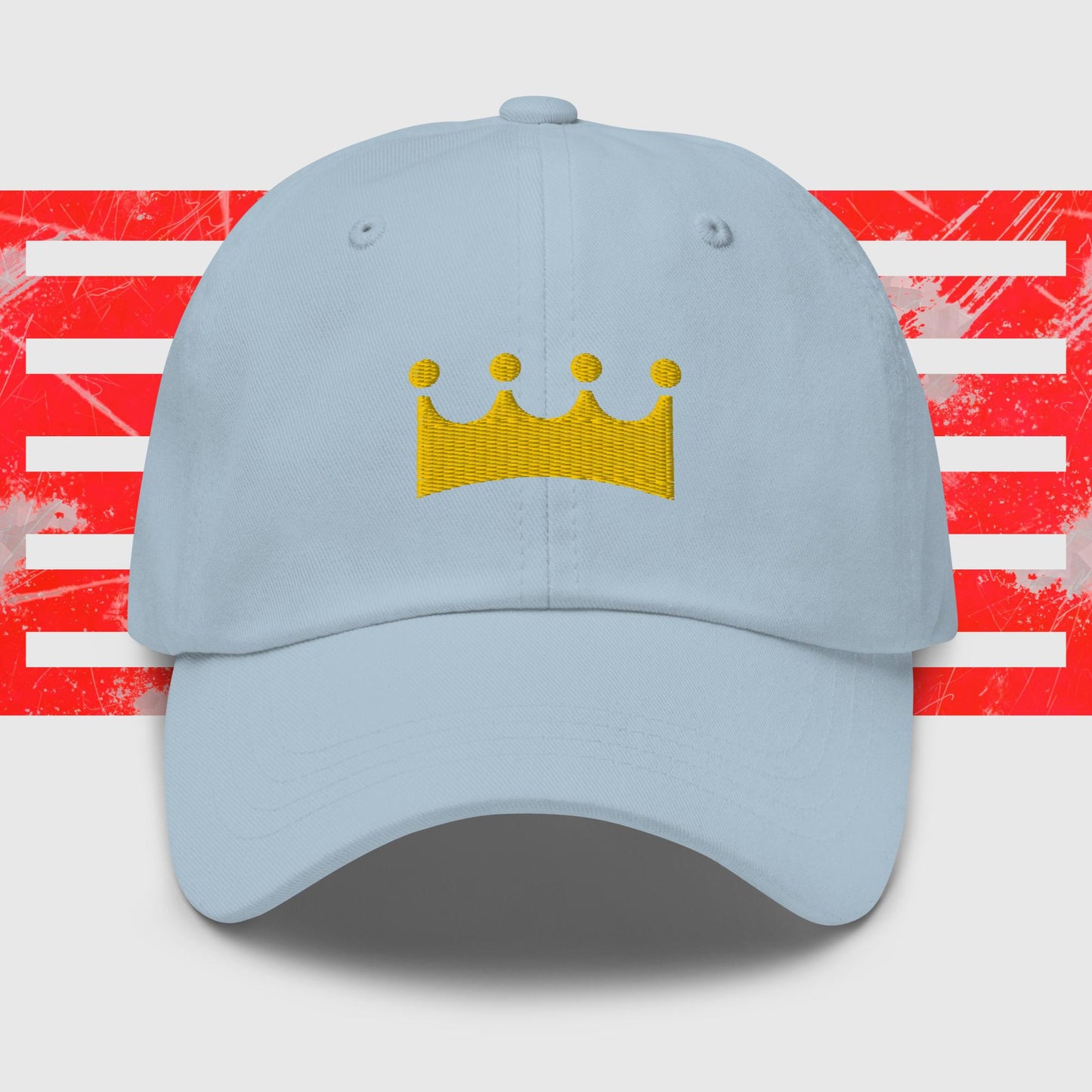 A black Royal Crown - Kansas City Royals Inspired Cap from KC Inspirations with a yellow crown emblem in the center. The background features abstract red and white stripes with a distressed texture, boasting embroidered graphics for added detail.