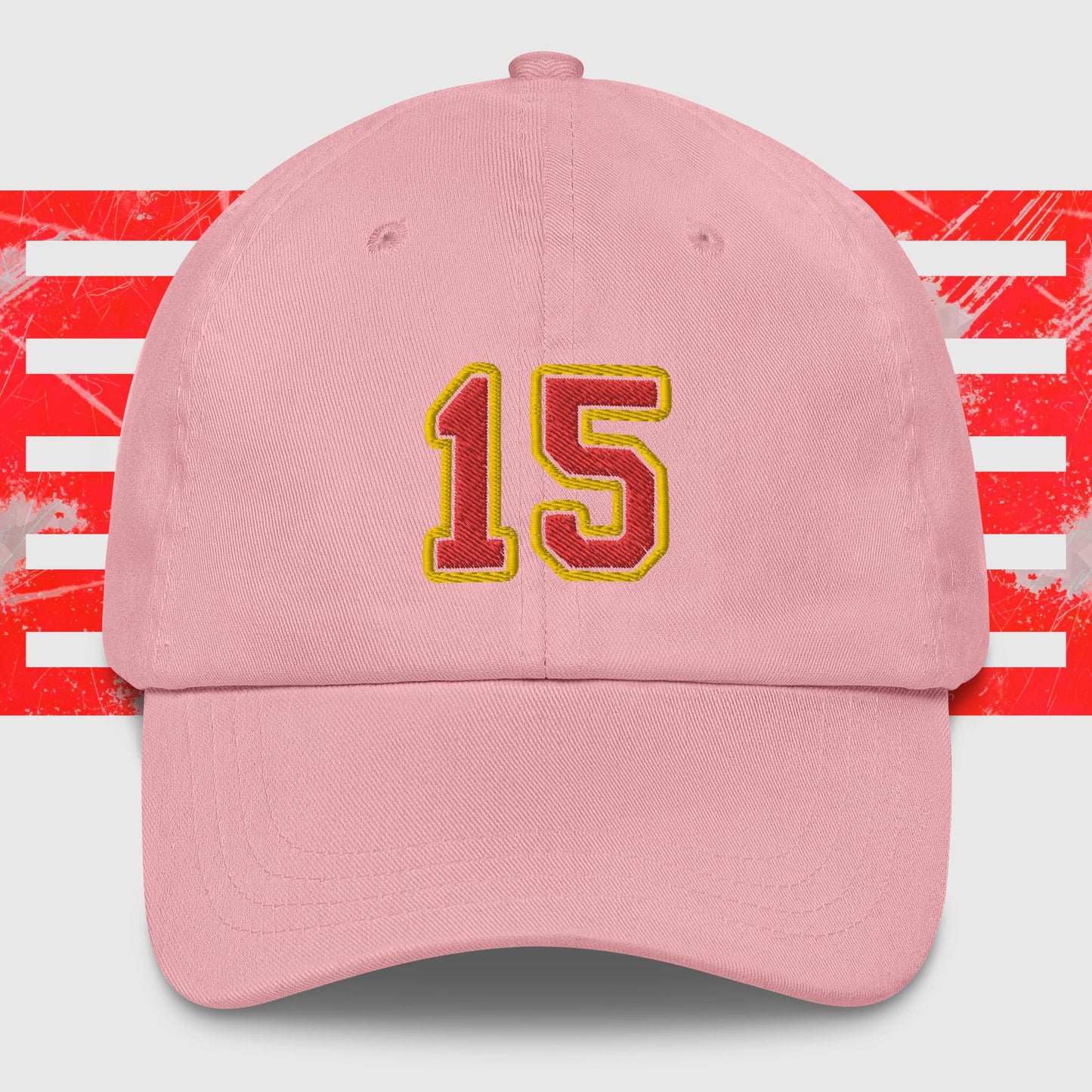 A black dad hat displays the number 15 in bold, yellow-outlined red embroidery on the front. The background features a graphic with vertical red and white stripes, paying homage to the Kansas City Chiefs. Introducing the Red & Gold 15 - Kansas City Chiefs Inspired Cap by KC Inspirations.