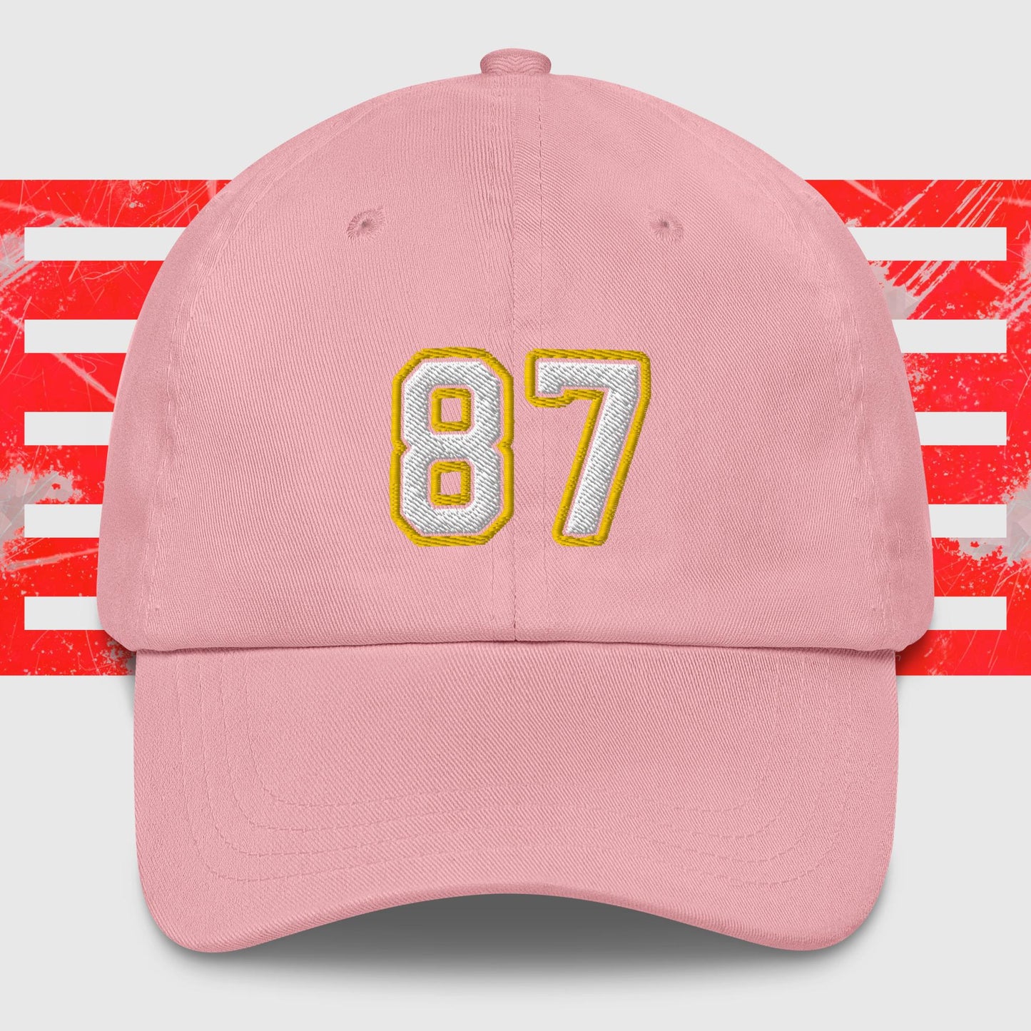 A White & Gold 87 - Kansas City Chiefs Inspired Cap from KC Inspirations. The background features red and white horizontal stripes with a distressed texture, reminiscent of Kansas City Chiefs spirit.