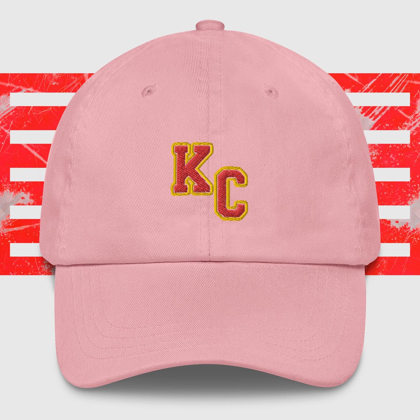 A KC Inspirations KC Red & Gold - Kansas City Chiefs Inspired Cap featuring the embroidered letters "KC" in red and yellow on the front. The background showcases red and white abstract stripes, making it a stylish choice for any Kansas City Chiefs fan.