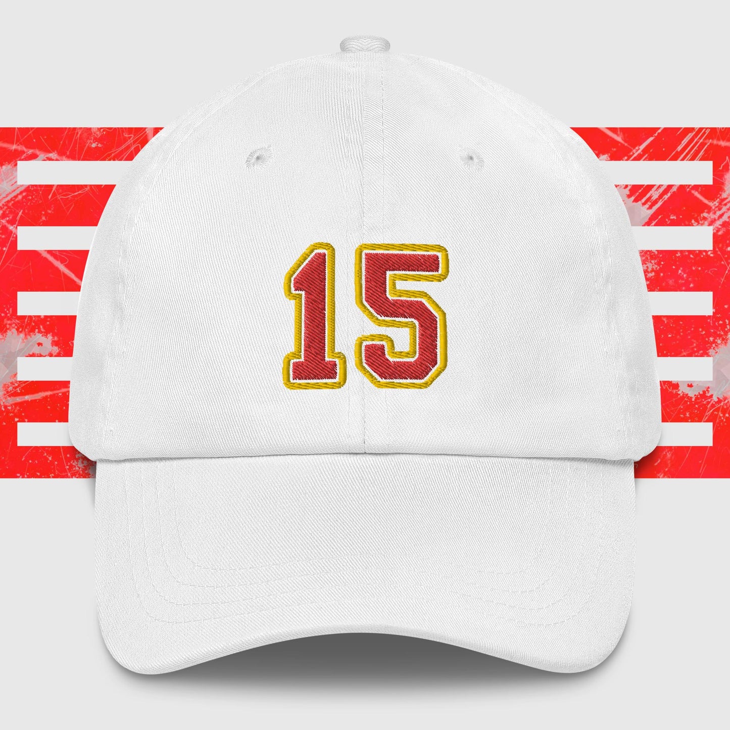 A black dad hat displays the number 15 in bold, yellow-outlined red embroidery on the front. The background features a graphic with vertical red and white stripes, paying homage to the Kansas City Chiefs. Introducing the Red & Gold 15 - Kansas City Chiefs Inspired Cap by KC Inspirations.